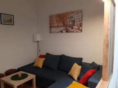 a living room with a blue couch and a table at Ilić Sokobanja in Soko Banja