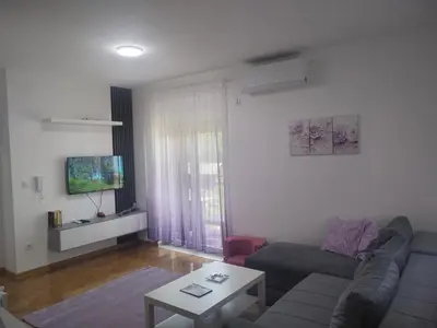 a living room with a couch and a table at Banjski kutak in Vrnjačka Banja