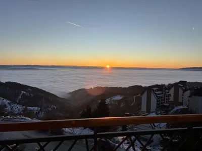 a view of the sun rising over the snow covered mountains at Squirrel Viewpoint Apartment Residence Hill B124 in Kopaonik