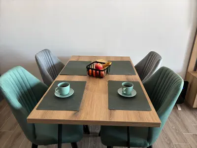 a wooden table with two cups and a basket of fruit at Squirrel Viewpoint Apartment Residence Hill B124 in Kopaonik