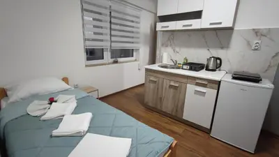 a small kitchen with a blue bed in a room at TNT accommodation in Niš