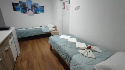 a room with two beds and a couch in it at TNT accommodation in Niš