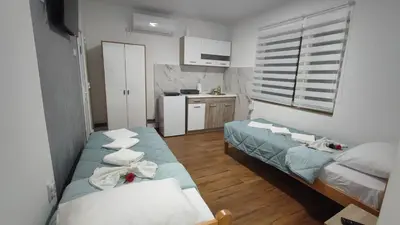 a small room with two beds and a kitchen at TNT accommodation in Niš