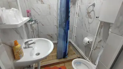 a small bathroom with a sink and a toilet at TNT accommodation in Niš