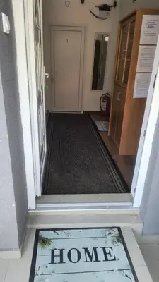 a hallway with a home sign on the door at TNT accommodation in Niš