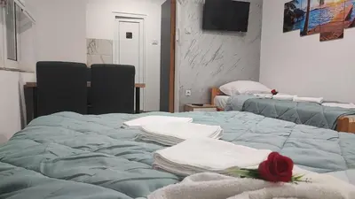 a room with two beds with towels on them at TNT accommodation in Niš