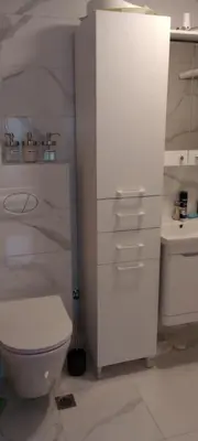 a white bathroom with a toilet and a sink at Apartmant Novaković in Vrnjačka Banja