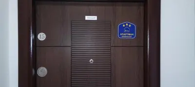 a wooden door with a sign on it at Apartmant Novaković in Vrnjačka Banja