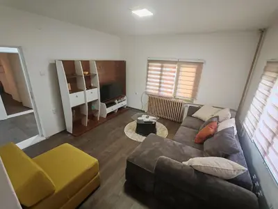 a living room with a couch and a tv at Apartmani Pegasus in Vranje