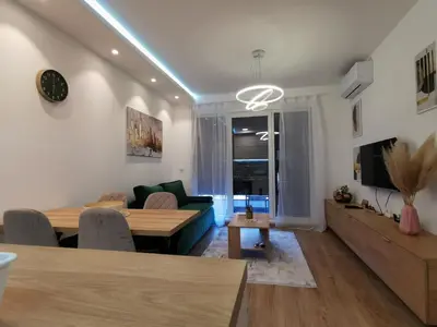 a living room with a table and a couch at Apartman Taris in Vrnjačka Banja