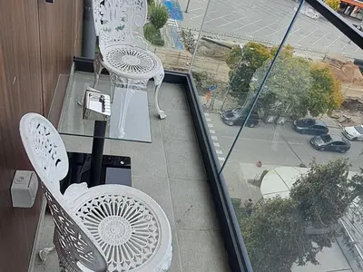 a balcony with two white chairs and a window at IL Paradiso potok akva park in Jagodina