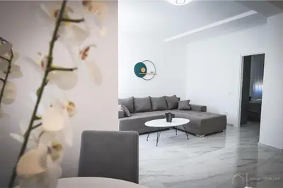a living room with a couch and a table at Aqua Vista Lux Raj in Vrnjačka Banja