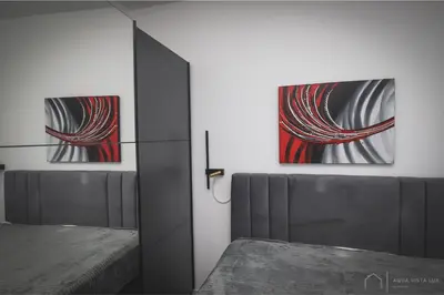 a bedroom with two paintings on the wall at Aqua Vista Lux Raj in Vrnjačka Banja