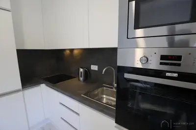 a kitchen with a sink and a microwave at Aqua Vista Lux Raj in Vrnjačka Banja