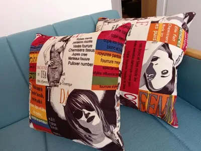 a pillow on top of a blue couch at Eli's apartment in Niš