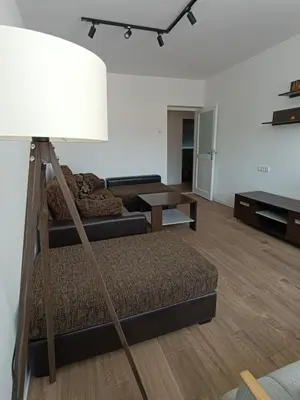 a living room with a bed and a lamp at Eli's apartment in Niš