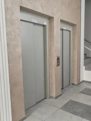 three elevators in a building with doors on the wall at Apartman Simijonovic in Trnava