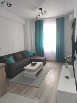 a living room with a couch and a table at Apartman Simijonovic in Trnava