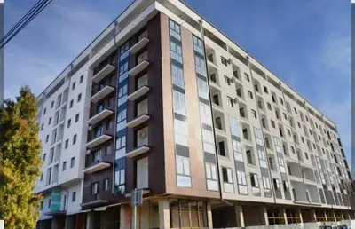 a large apartment building on the corner of a street at Apartman Simijonovic in Trnava