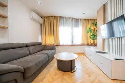 a living room with a couch and a table at Apartman Simonovic in Vrnjačka Banja