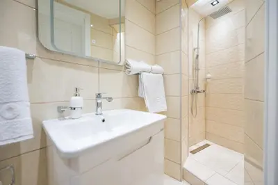 a bathroom with a sink and a shower at Apartman Simonovic in Vrnjačka Banja
