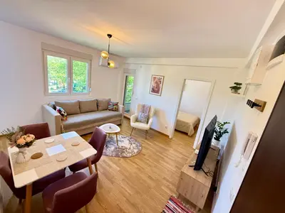 a living room with a couch and a table at Tajna Ozrena - Sokobanja in Soko Banja