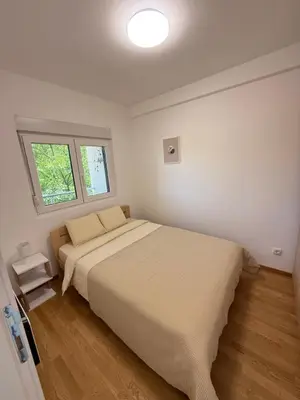 a bedroom with a large bed and a window at Tajna Ozrena - Sokobanja in Soko Banja