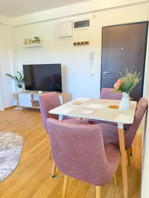 a dining room with a table and purple chairs at Tajna Ozrena - Sokobanja in Soko Banja