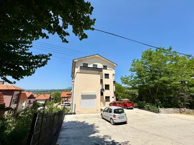 a white car parked in front of a building at Tajna Ozrena - Sokobanja in Soko Banja