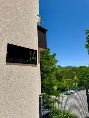 a sign on the side of a building with a parking lot at Tajna Ozrena - Sokobanja in Soko Banja