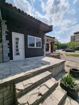 a house with a stone patio and a white door at Stan na dan Bor FREE PARKING in Bor