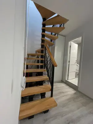 a wooden spiral staircase in a house at Stan na dan Bor FREE PARKING in Bor