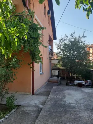 a orange building with a person standing next to it at Anika in Soko Banja