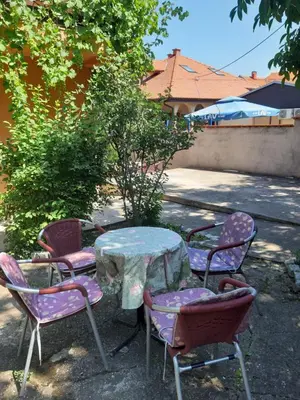 a table and four chairs with a table and a table at Anika in Soko Banja