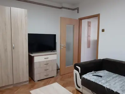a living room with a couch and a flat screen tv at Anika in Soko Banja