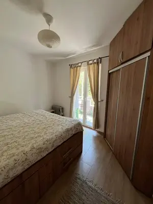 a bedroom with a bed and a dresser and a window at Na Banjici in Soko Banja