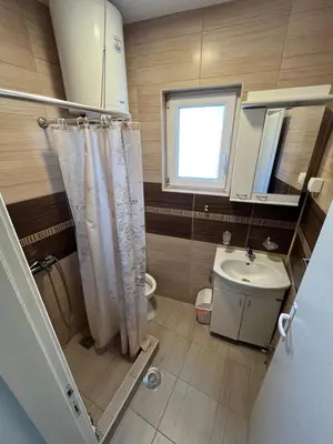 a bathroom with a sink and a toilet and a window at Na Banjici in Soko Banja