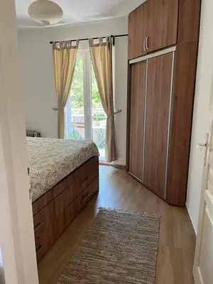 a bedroom with a bed and a large window at Na Banjici in Soko Banja