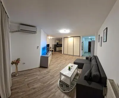 a living room with a couch and a table at Luxury apartment in the city center in Zaječar