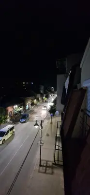 a city street at night with cars on the road at Luxury apartment in the city center in Zaječar