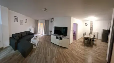 a living room with a couch and a flat screen tv at Luxury apartment in the city center in Zaječar