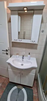 a bathroom with a sink and a mirror at Luxury apartment in the city center in Zaječar