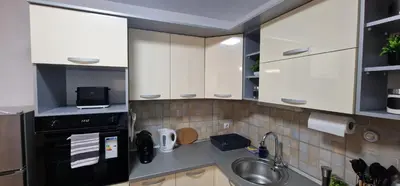 a kitchen with white cabinets and a sink at Luxury apartment in the city center in Zaječar