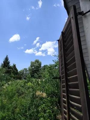 an open door of a house with trees in the background at Vikendica Nina in Bor