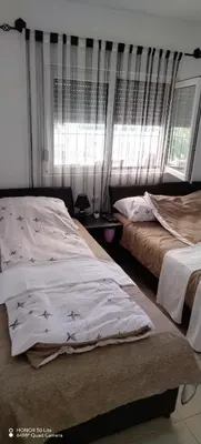 a bedroom with two beds and a window at Sobe Paunović in Soko Banja