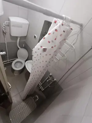 a bathroom with a shower curtain with hearts on it at Sobe Paunović in Soko Banja