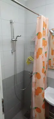 a shower curtain in a bathroom with a sink at Sobe Paunović in Soko Banja