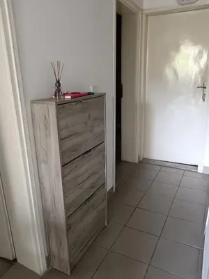 a wooden dresser in a room with a door at Sobe Paunović in Soko Banja