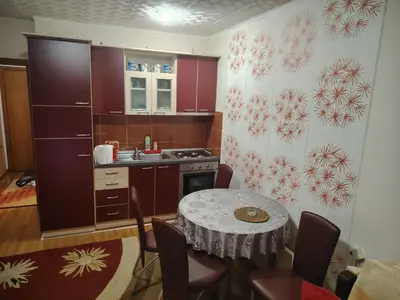 a small kitchen with a table and a sink at Apartman Milosavljevic in Vrnjci