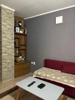 a bedroom with a bed and a coffee table at Apartmani Radovanovic in Soko Banja